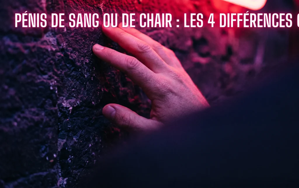 Pénis de sang ou de chair : les 4 différences clés 3 Main posée sur un mur sombre sous un éclairage néon cerise pour aborder le sujet morphologique des pénis de sang ou de chair