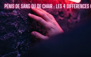 Main posée sur un mur sombre sous un éclairage néon cerise pour aborder le sujet morphologique des pénis de sang ou de chair
